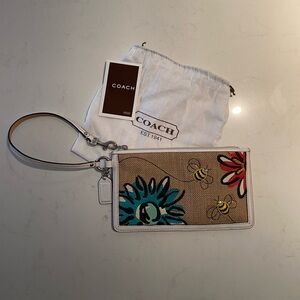 Coach wristlet/pouch with bumble bees and flowers.